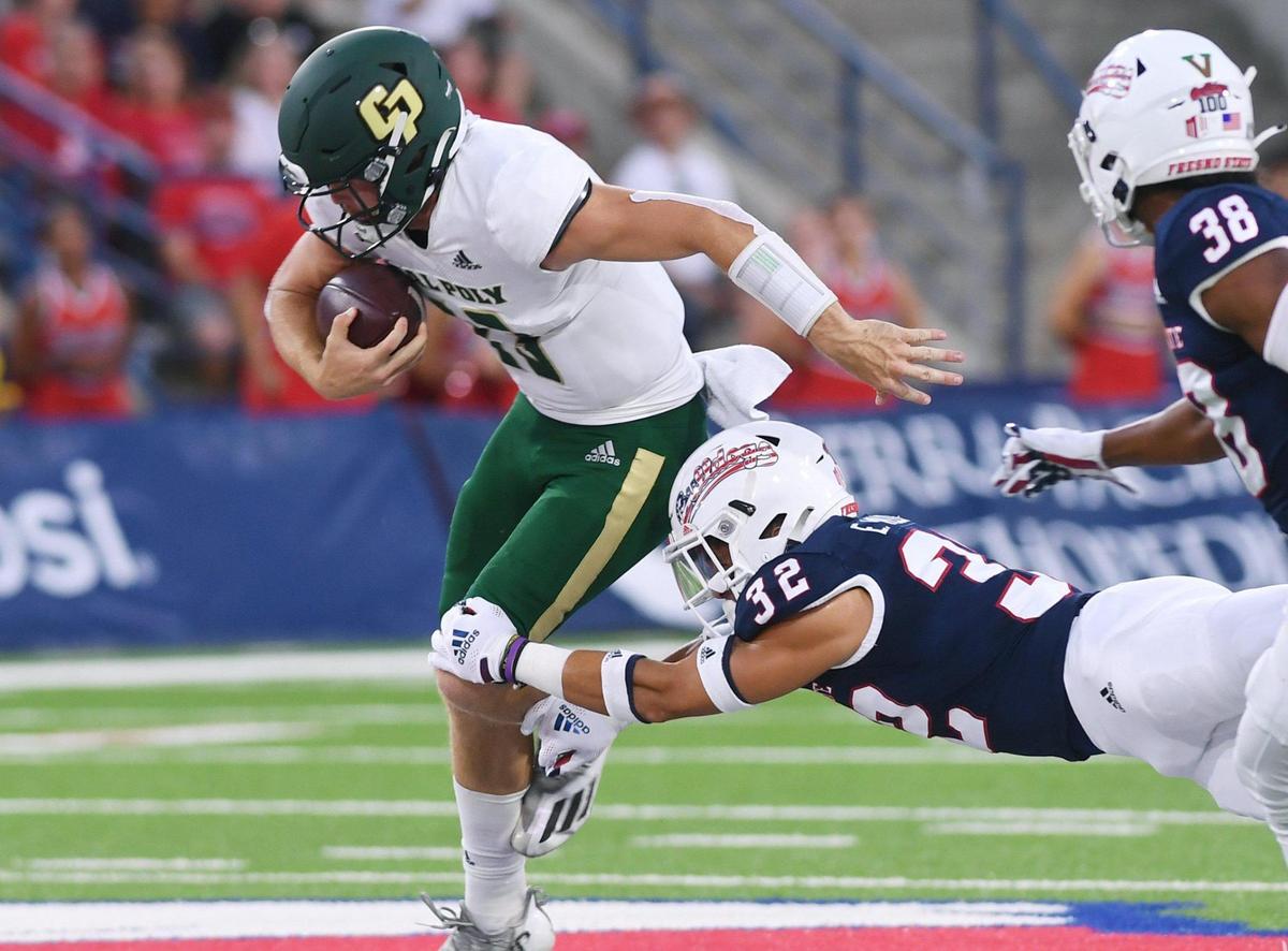 Fresno State’s Evan WIlliams, right, tackles Cal Poly’s scrambling quarterback Spencer Brasch, right, Saturday, Sept. 11, 2021 in Fresno.
