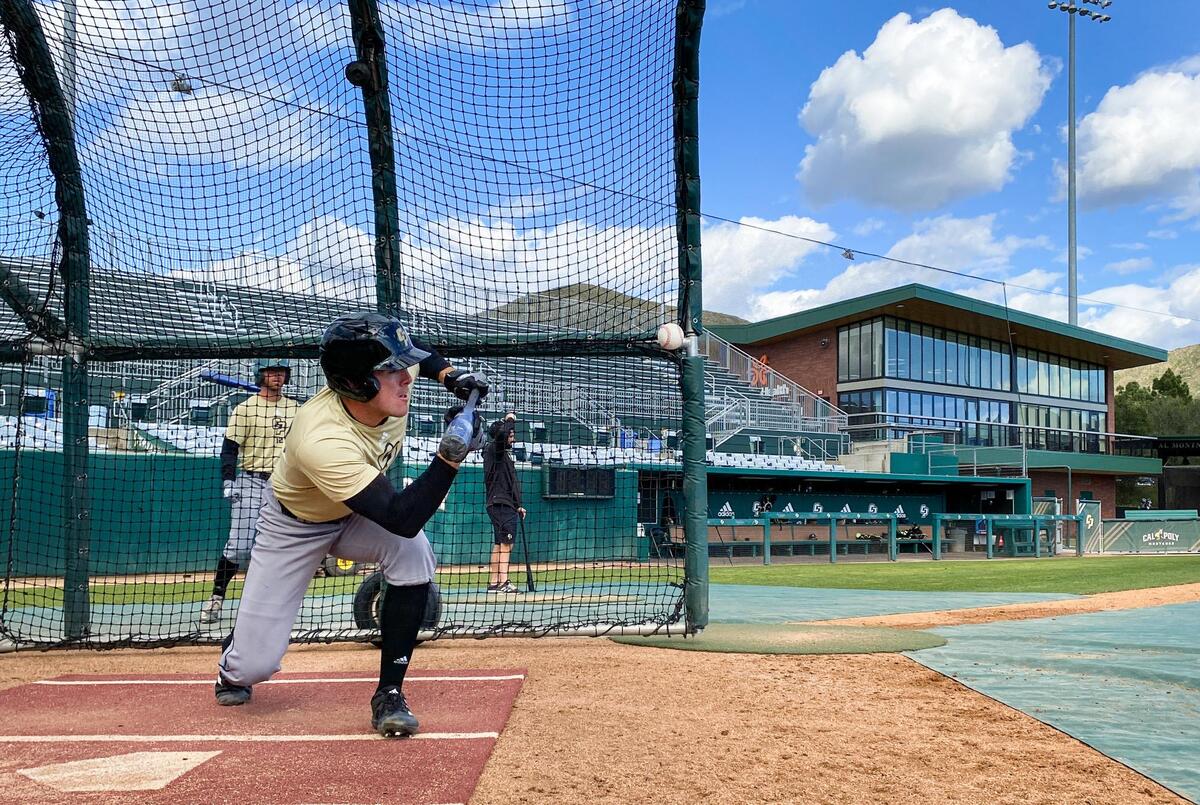 Reagan Doss squares around for a bunt in the batting cage during a Cal Poly practice on Feb. 16, 2022.