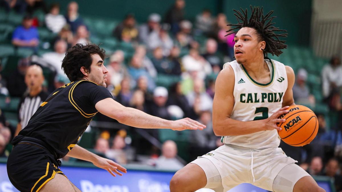 Justin Page battles to find some space as Isa Silva defends. Long Beach state won 89-82 at Cal Poly’s Mott gym Jan. 4, 2024.