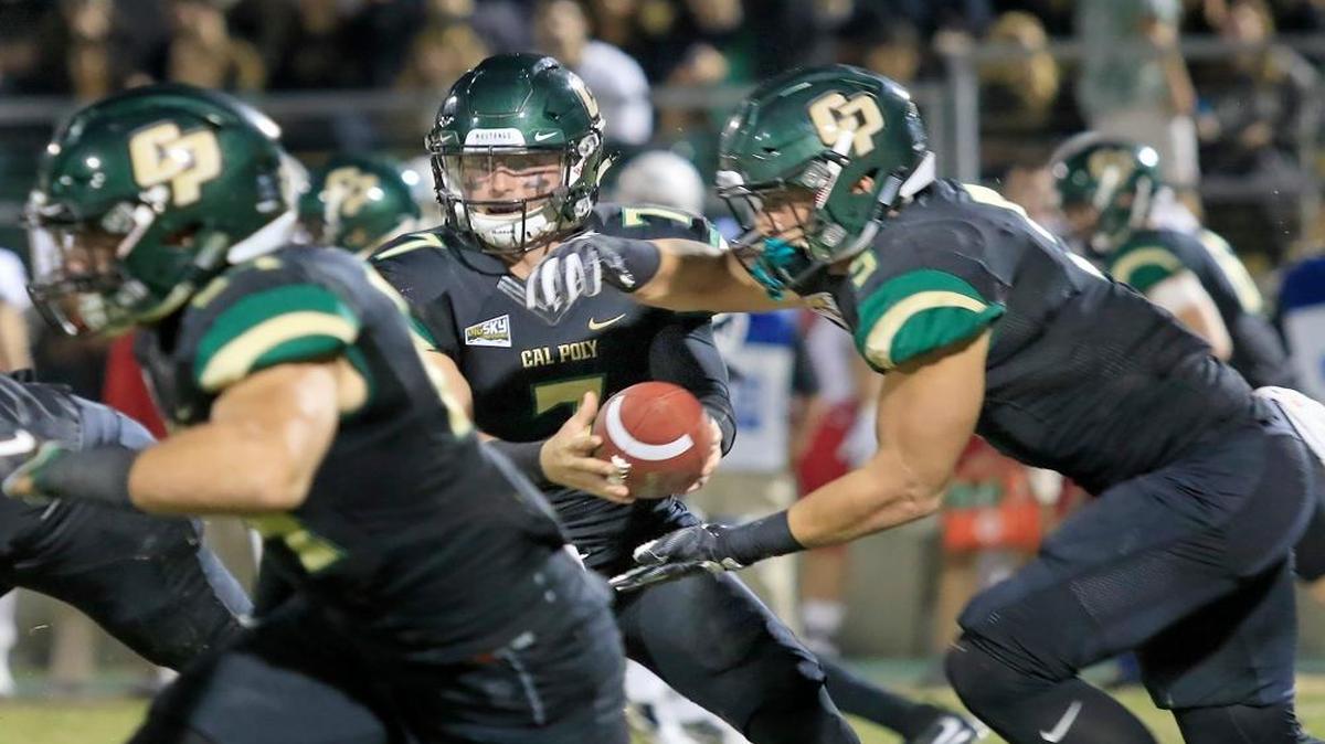 Cal Poly quarterback Dano Graves hands the ball off to fullback Joe Protheroe last week. The Mustangs play Weber State at 11 a.m. Saturday at Stewart Stadium in Ogden, Utah.