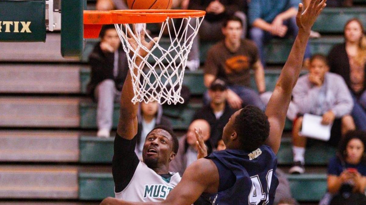 Cal Poly’s David Nwaba shoots over a defender during a nonconference men’s basketball game at Mott Athletics Center.