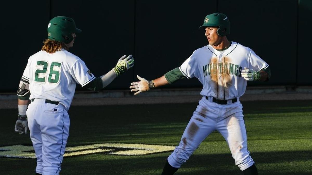 Nick Meyer, left, congratulates Alex McKenna, who scored the first run of the game against Wichita State on March 17, 2017.