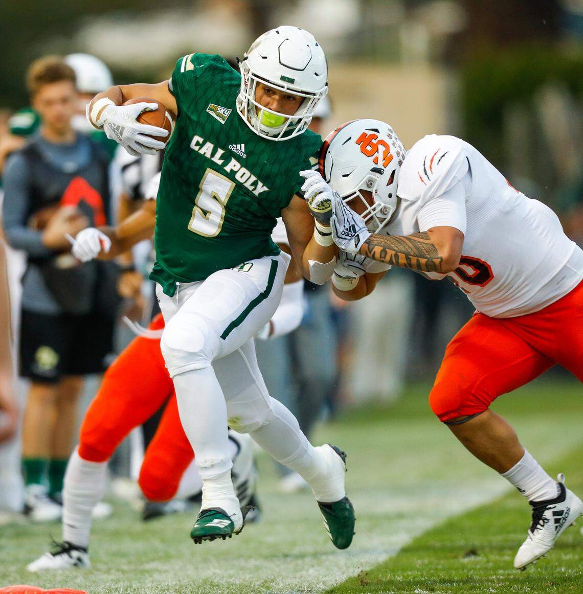 Cal Poly’s Joe Protheroe is pushed out of bounds by Idaho State’s Aren Manu during an NCAA college football game in San Luis Obispo, Calif., Saturday, Nov. 10, 2018. Protheroe disagrees with the NCAA decision to vacate student records over a textbook payment violation.