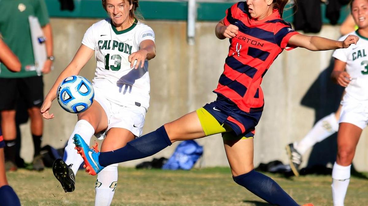 Cal Poly’s Elise Krieghoff (13) keeps the ball away from Cal State Fullerton’s Morgan Batchellor (11) during the second half of the Mustangs’ 2-1 loss on Sunday at Alex G. Spanos Stadium.