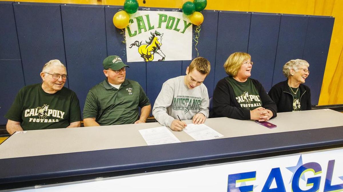 Arroyo Grande’s Bradley Mickey signs his National Letter of Intent to play football at Cal Poly. He is seated with his grandfather Roy, left, his father Larry, his mother Cyndi and grandmother Bobbye McNamara.