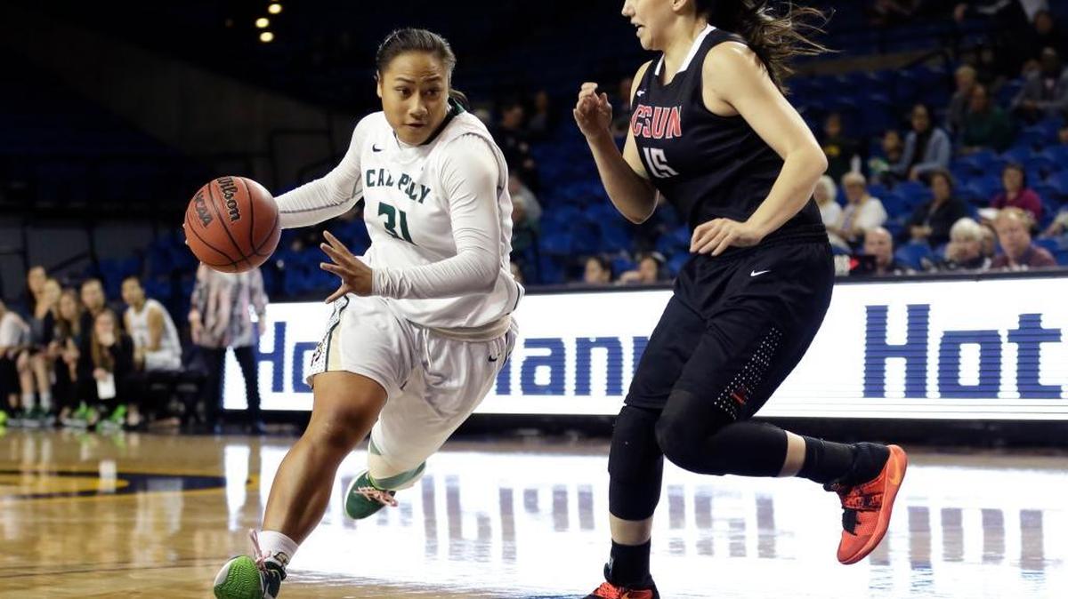Cal Poly guard Dynn Leaupepe (13) drives past Cal State Northridge guard Claudia Ramos (15) during the first half of a Big West Conference Tournament game Tuesday in Irvine.
