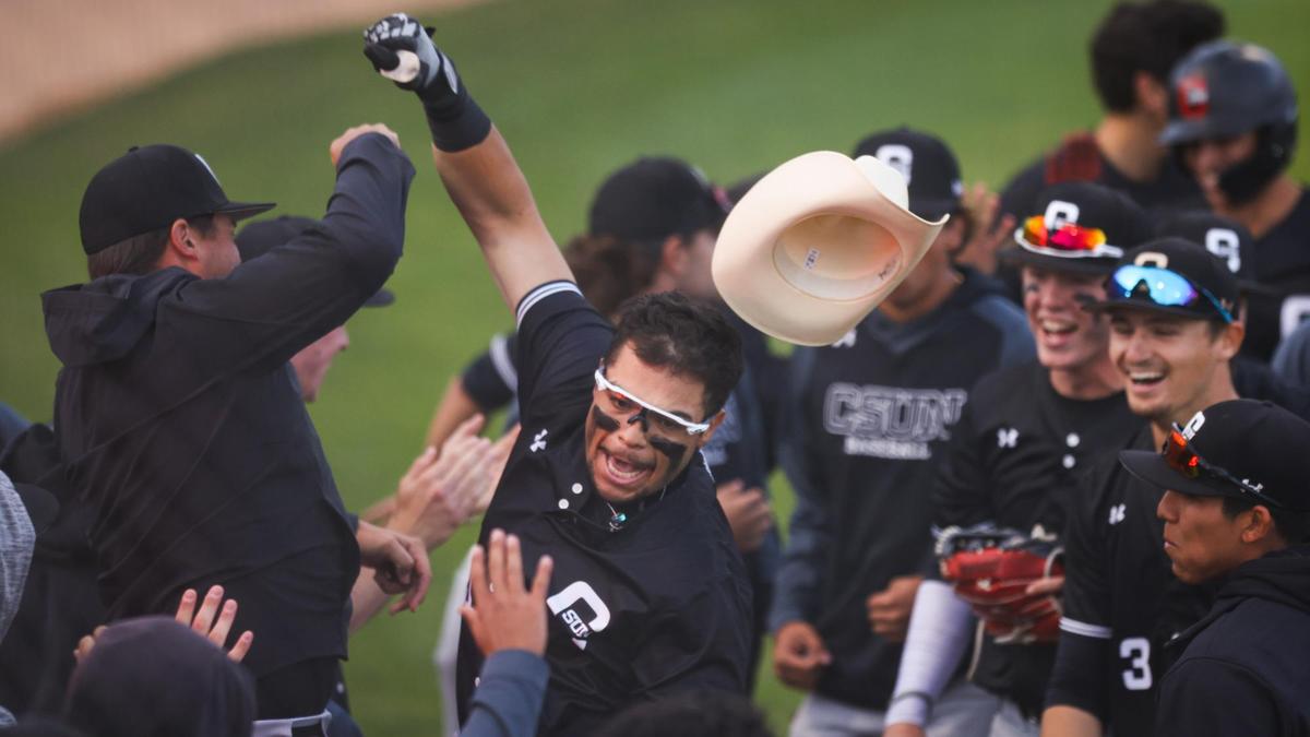 Gabe Gonzalez gives arm bumps and celebrates his a grand slam for Northridge but Cal Poly came from behind to win over CSUN 6-4 during the Big West Conference opener in San Luis Obispo, Friday, March, 18, 2022.
