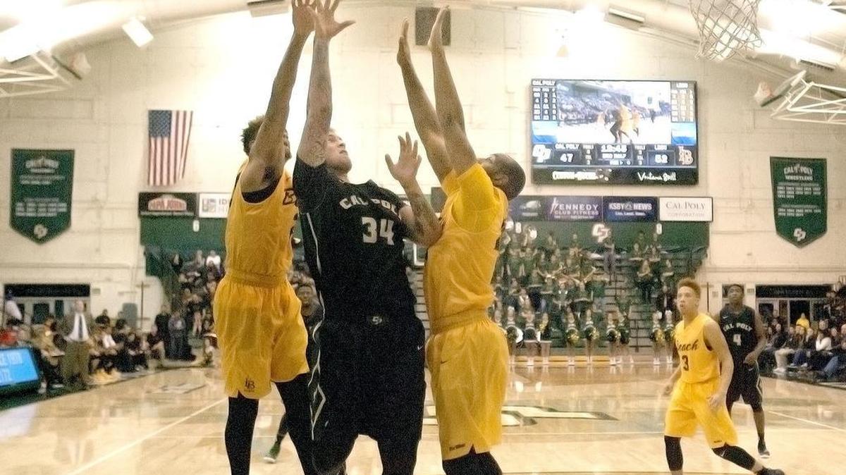 Cal Poly Mustangs hosts Long Beach State University at Moth Athletic Center, Saturday, January 16. Cal Polyâ€™s Brian Bennett (34) goes for a shot against Long Beach’s Roschon Prince (23), left, and Travis Hammonds (24) in second half play.