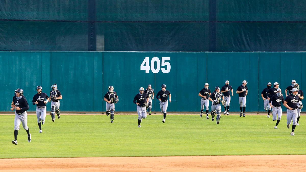 Cal Poly baseball players run during practice at Baggett Stadium.