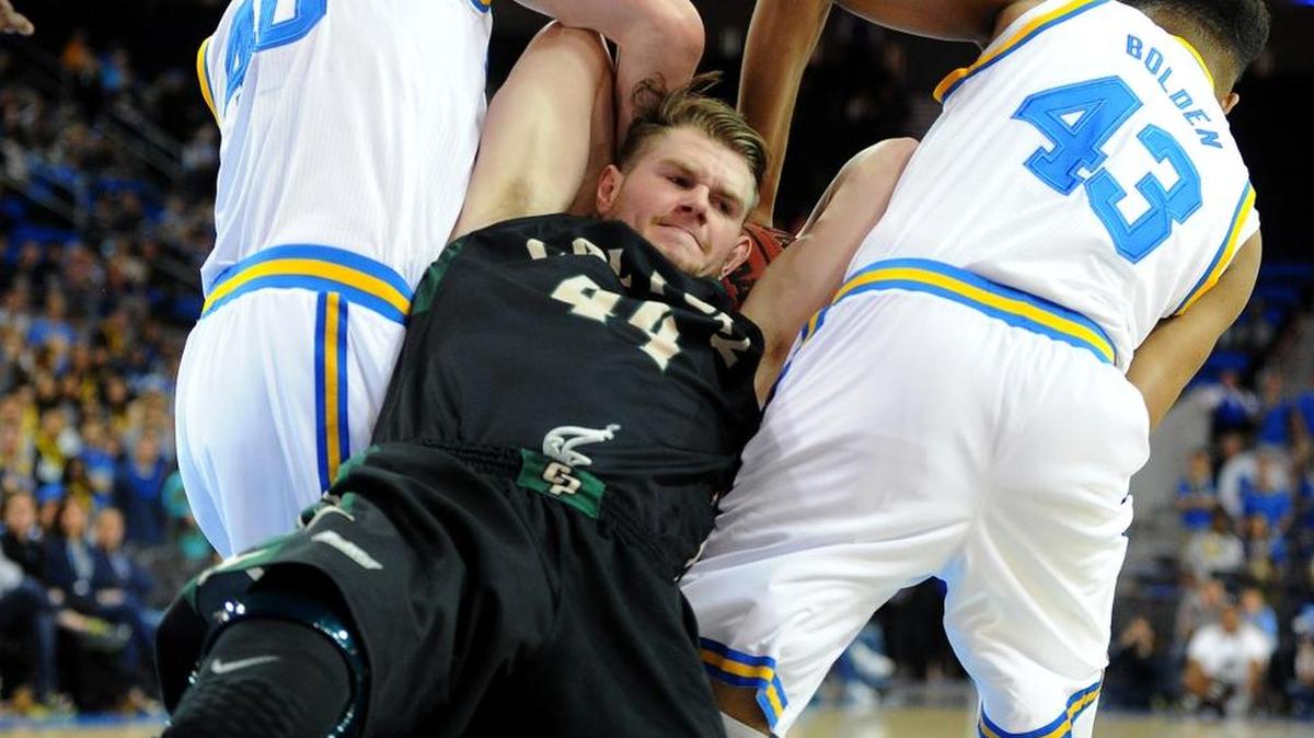 Cal Poly’s Zach Gordon is tied up on a rebound by UCLA’s Thomas Welsh, left, and Jonah Bolden during the first half of an NCAA college basketball game in Los Angeles, Sunday, Nov. 15, 2015.