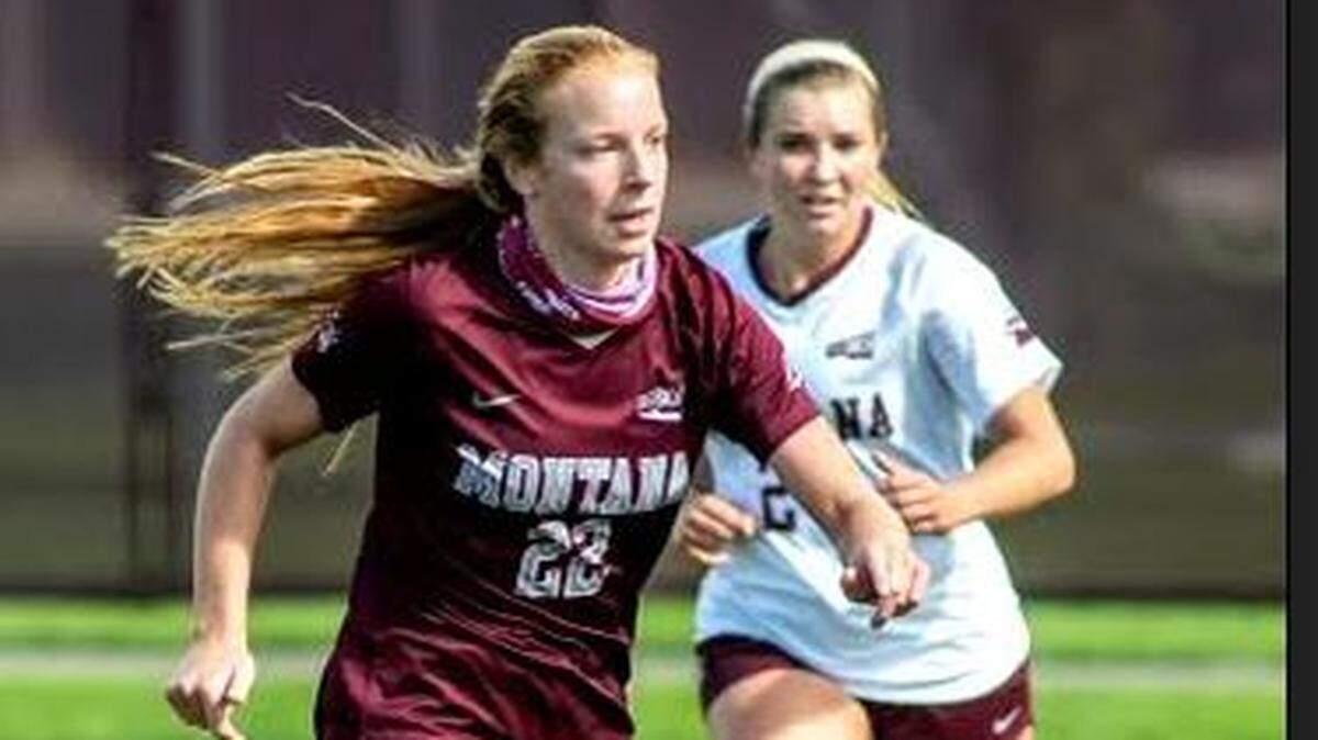 Molly Massman dribbles the ball while playing for the University of Montana.