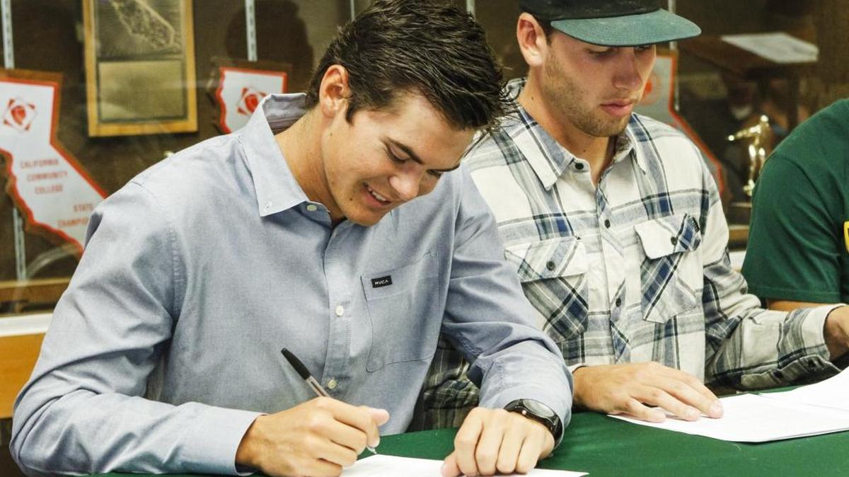 Baseball players Louis Raymond, left, is heading to UC Irvine and Neil Uskali is off to Hawaii as they and other athletes signed their letters of intent Thursday during Cuesta College’s signing day.