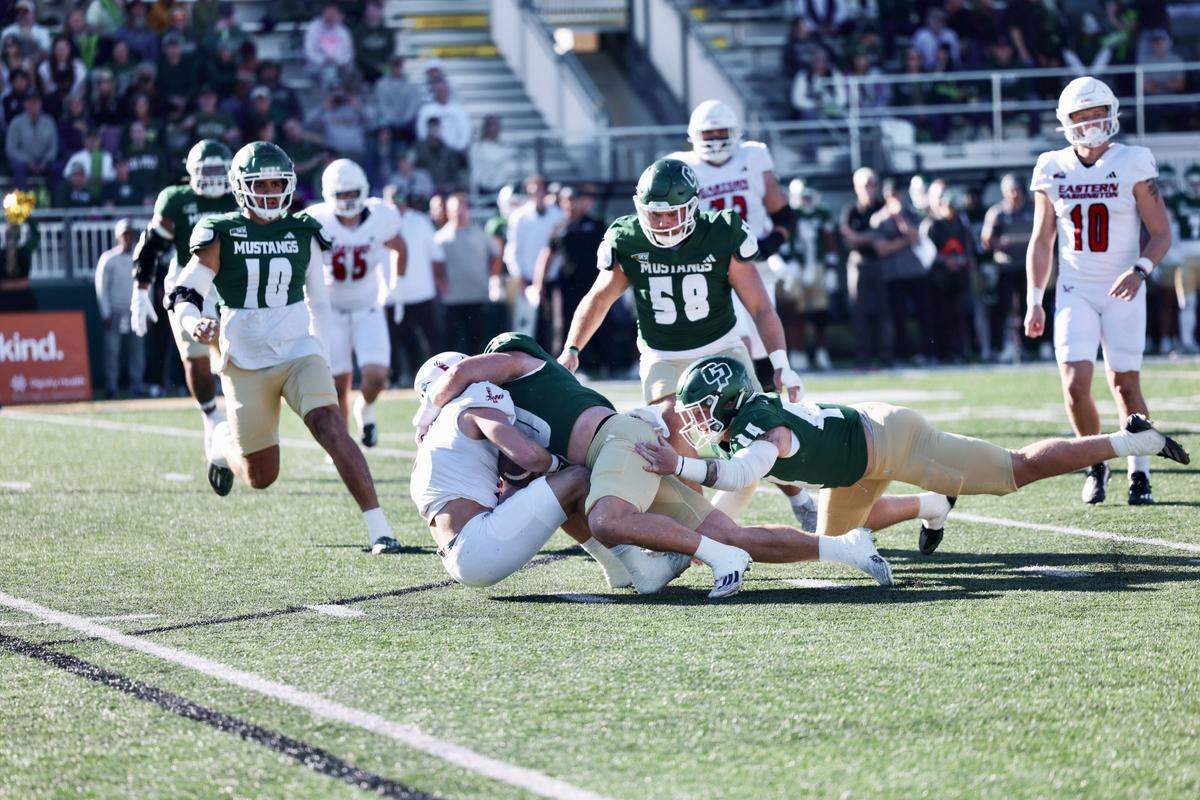Cal Poly defenders take down a ball carrier for Eastern Washington in a 43-34 win on Nov. 22, 2025.