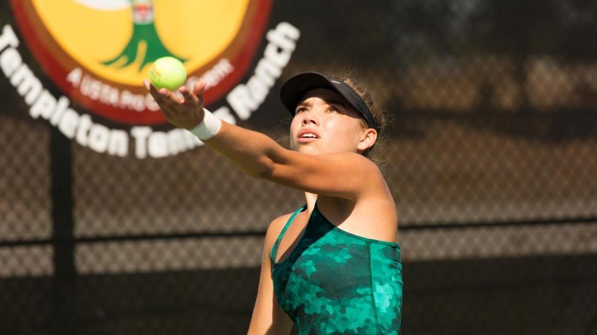 Arroyo Grande High School junior Delanie Dunkle tosses a serve during her doubles match at the first annual Central Coast Classic, a $60,000 women’s USTA Pro Circut event taking place at the Templeton Tennis Ranch.