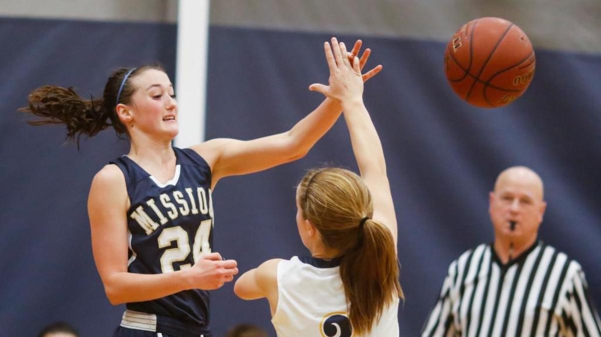 Mission Prep’s Jennifer Laird passes the ball over an Arroyo Grande defender during a Jan. 11 game.