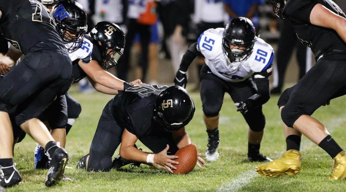 San Luis Obispo High School lineman Chad Lincoln recovers a fumble in a non-conference game Friday against Hanford West.