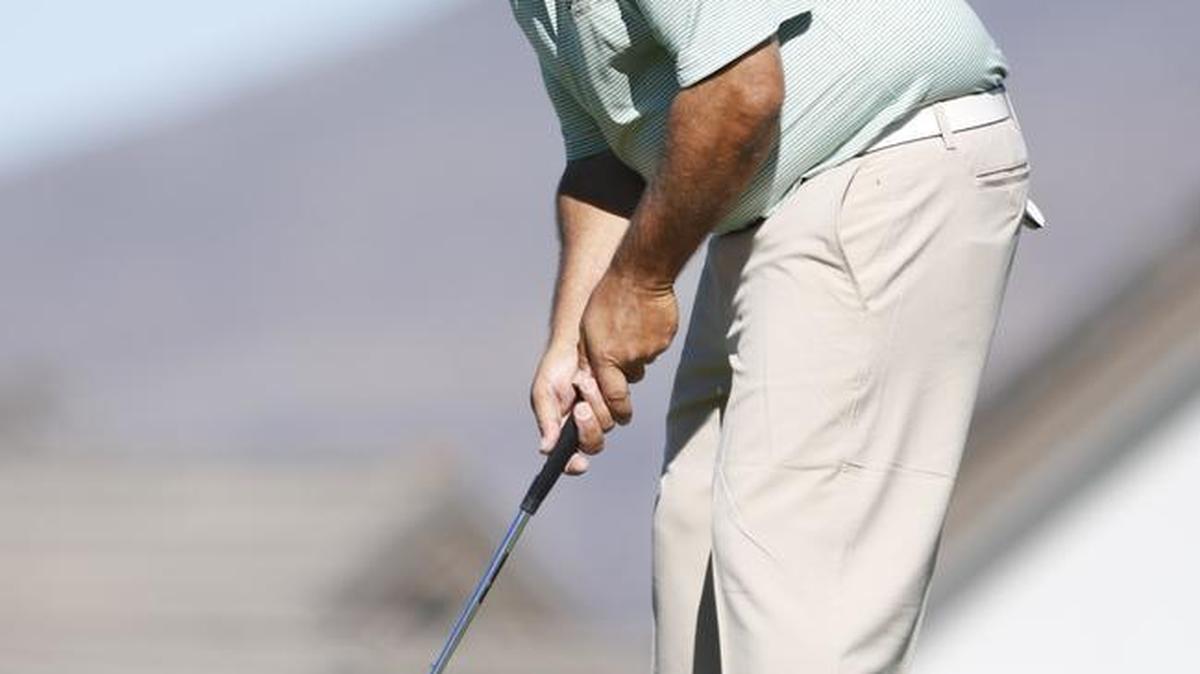 Cal Poly golf coach Scott Cartwright putts on the green during the 19th annual Straight Down Fall Classic on Saturday.