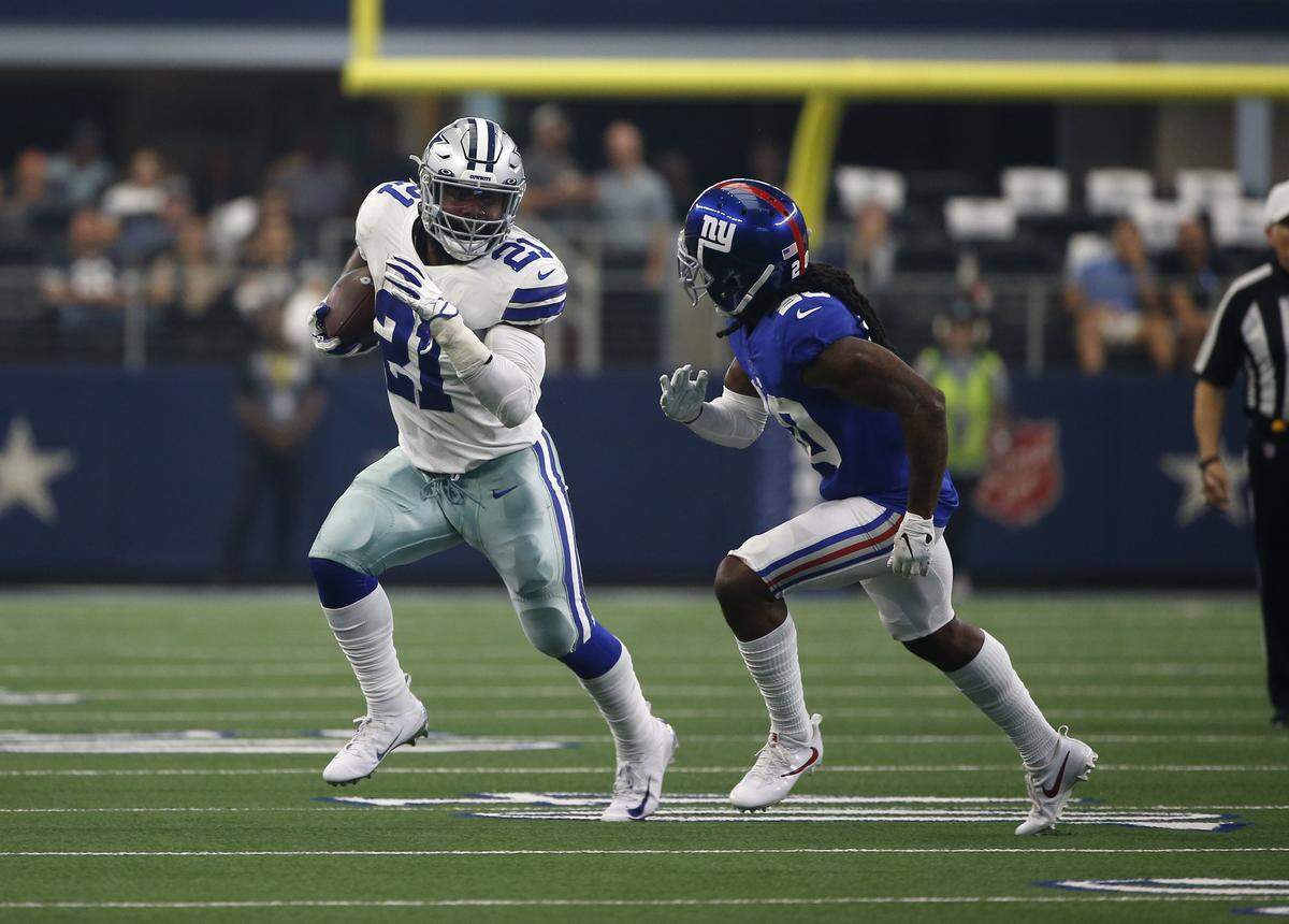 Dallas Cowboys running back Ezekiel Elliott (21) finds running room as New York Giants cornerback Janoris Jenkins (20) defends during a NFL football game in Arlington, Texas, Sunday, Sept. 8, 2019.