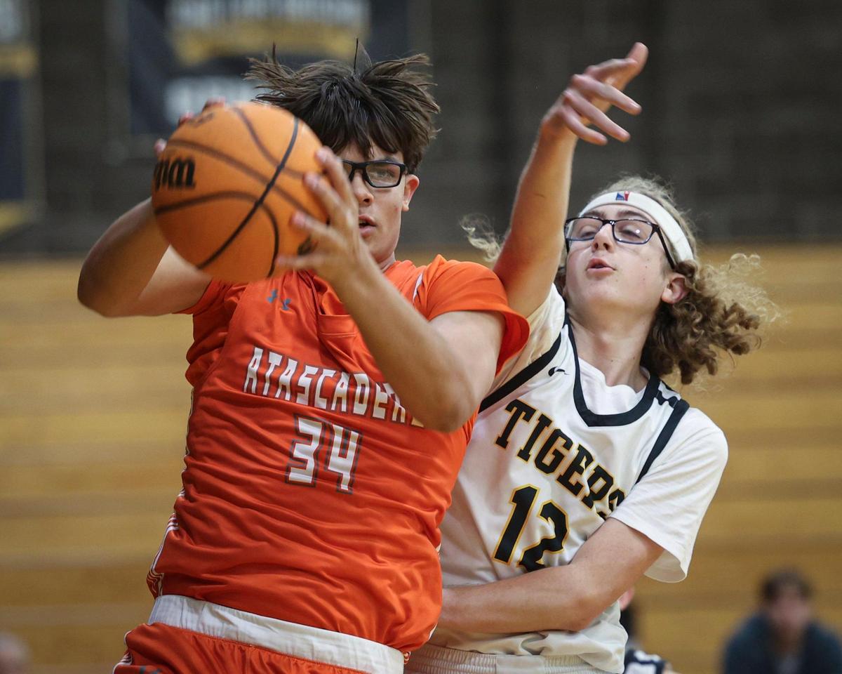 Kason Niko grabs a rebound as Isaac Burgess reaches for ball. Atascadero High School beat San Luis Obispo 60-57 on Jan. 21, 2025.
