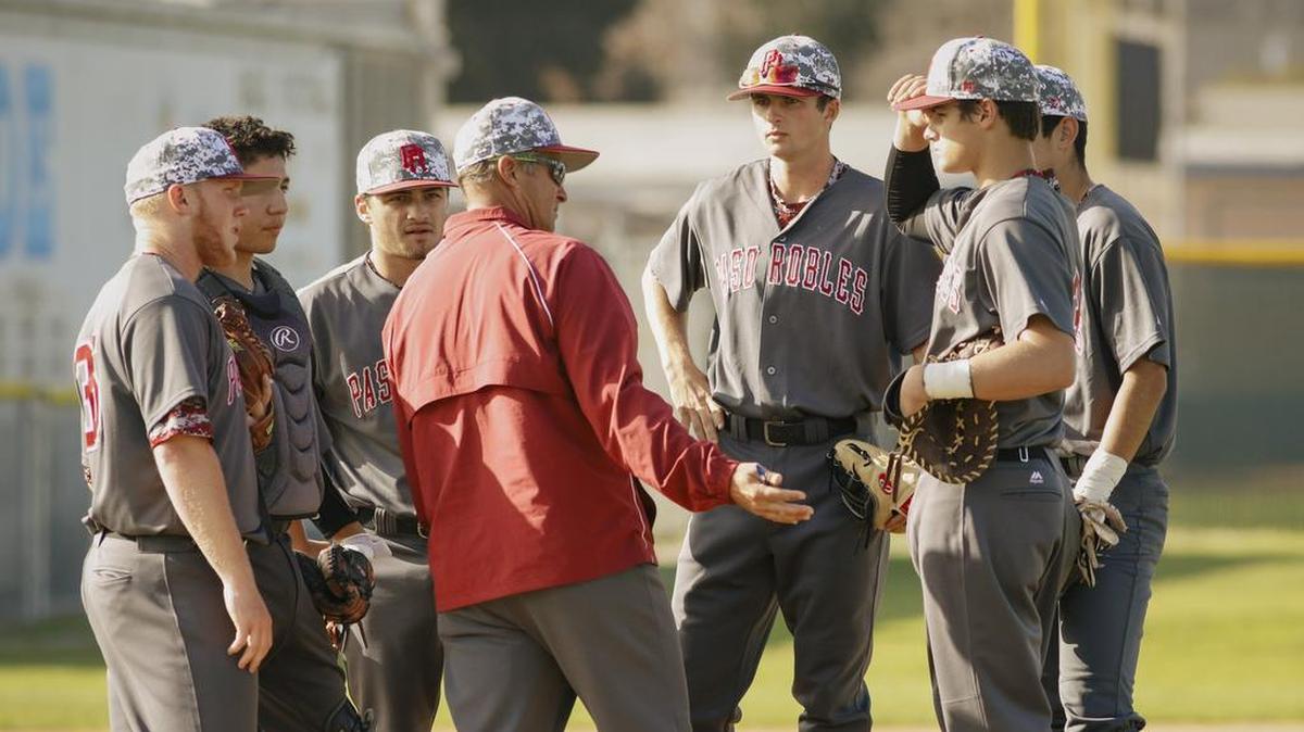Paso Robles High baseball coach Derek Stroud talks to his team, including son Will Stroud (middle), during a game against Arroyo Grande in 2018.