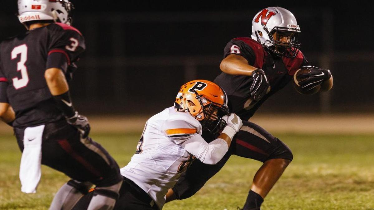 Santa Ynez defender Jasper Kadlec corrals Nipomo running back Isaac Bausley.