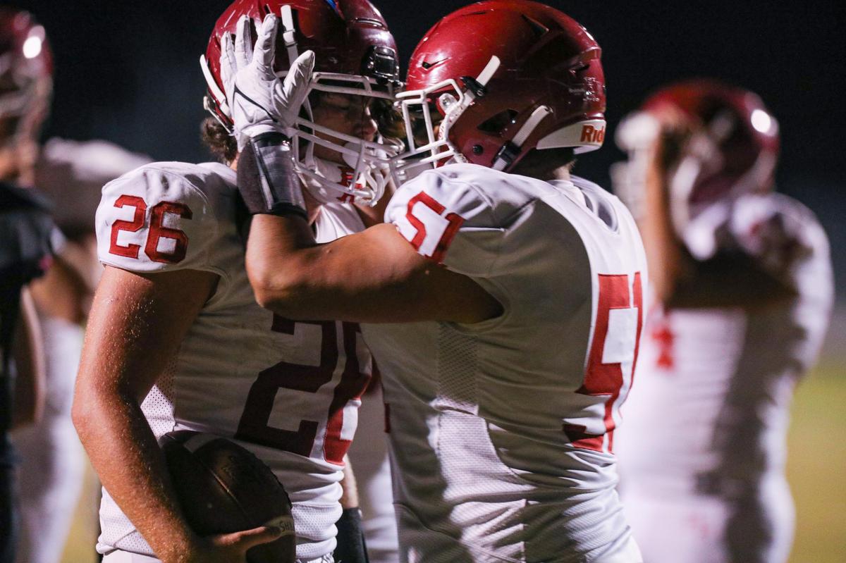 Leo Kemp is congratulated by Brian Ibarra after scoring a touchdown in Paso Robles’ 19-12 win over Nipomo on Oct. 8, 2021.