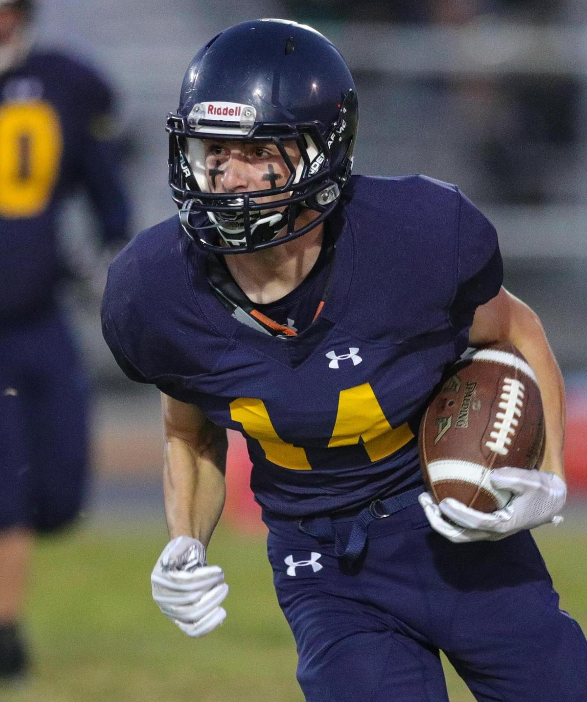 Bret Pinkerton carries the ball. San Luis Obispo traveled to Arroyo Grande for a football game.