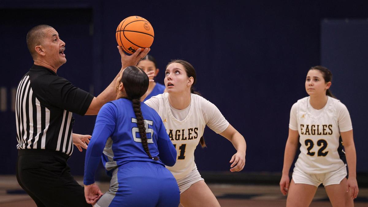 Arroyo Grande’s Diana Sorrondo prepares for the tip-off against Jaylee Moore from Caruthers High School. Sophia Robertson is at right. Caruthers beat Arroyo Grande 51-36 in a girls basketball playoff game on Feb. 14, 2024.