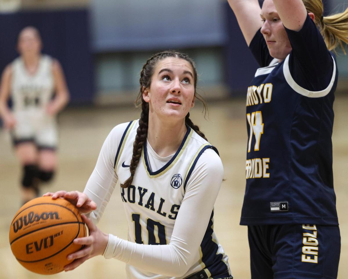 Reese Weisenberg shoots as Ellie Sloan defends. Mission Prep girl’s basketball team beat Arroyo Grande 55-51 on Feb. 11, 2025.