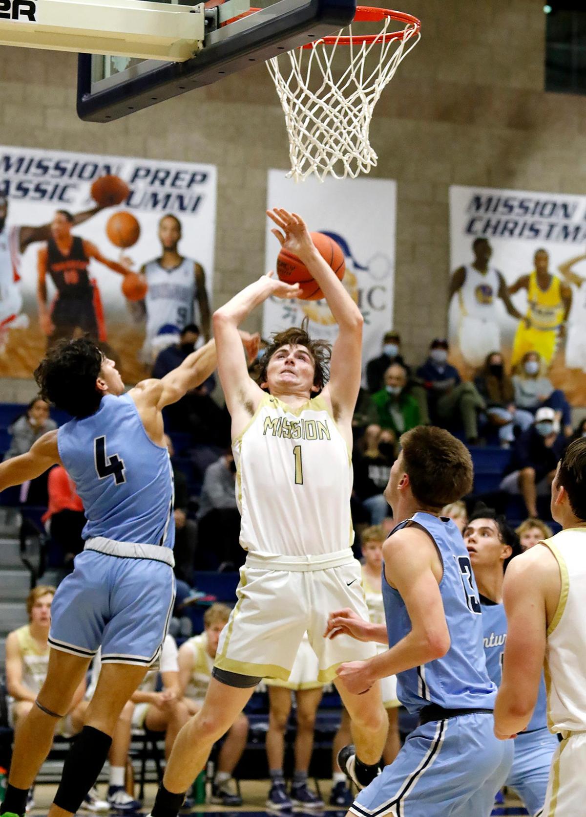 Mission Prep’s Grant Callahan (1) gets the ball knocked out by Saugus’ Cristian Manzano(4). The Mission Prep Classic basketball tournament is underway with some of the top teams in the state.