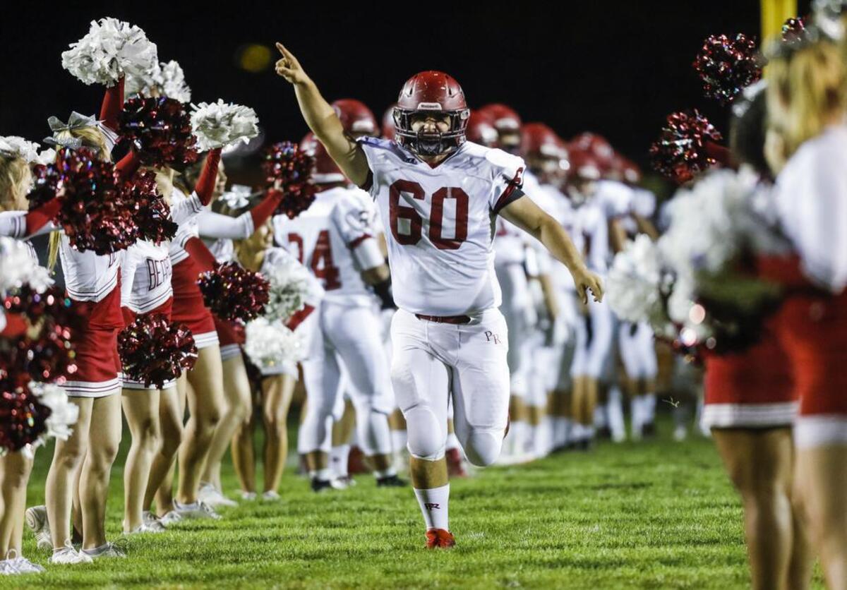 Paso Robles players run onto the field ahead of the 2016 rivalry football game against Atascadero.