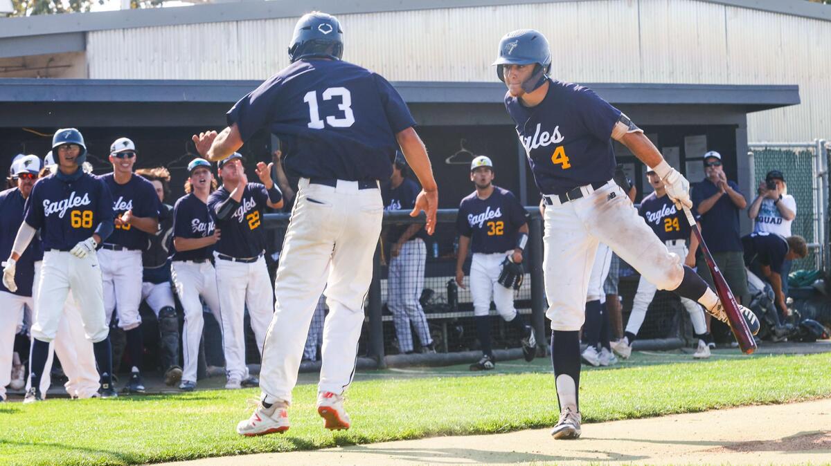 Tyler Hamilton, left celebrates scoring the second run with Drew Baskin. Aggressive base running and errors on Paso Robles led to the runs. Arroyo Grande hosted Paso Robles in a playoff baseball game in the delayed COVID-19 season.