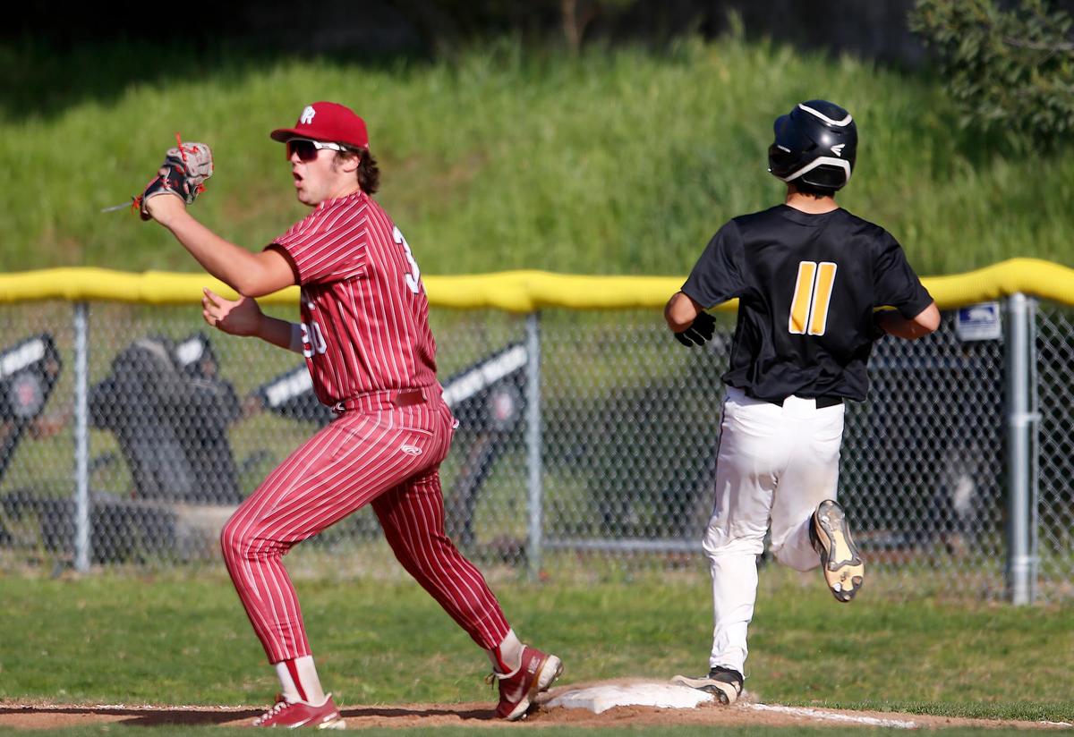 Paso Robles’ Tanner O’Farrell (30) makes the out on San Luis Obispo runner Ayden Kim (11) at first base. San Luis Obispo Tigers beat Paso Robles High 12-5 at Taylor Field in San Luis Obispo on Friday.