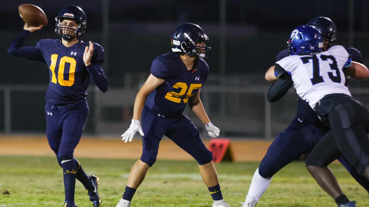 Max Perrett throws as Junior Herlihy looks to block. AG High opened its 2021 fall season against Frontier of Bakersfield.