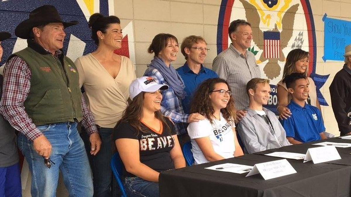 Morro Bay athletes (from left) Fallon Molnar, June Janzen, Andrew Stafford and Marjoe Delacruz sign National Letters of Intent at Morro Bay High School surrounded by family and friends.