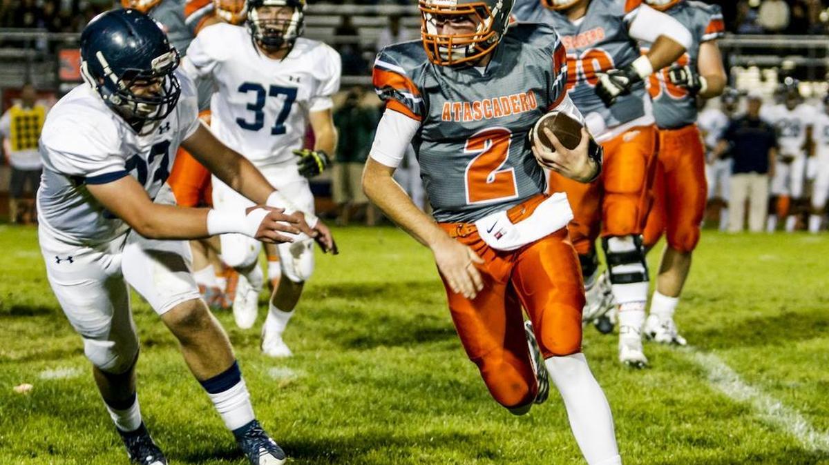 Arroyo Grande High’s Jack Ventura chases Atascadero quarterback Carson Rinkenberger in Friday night’s game.