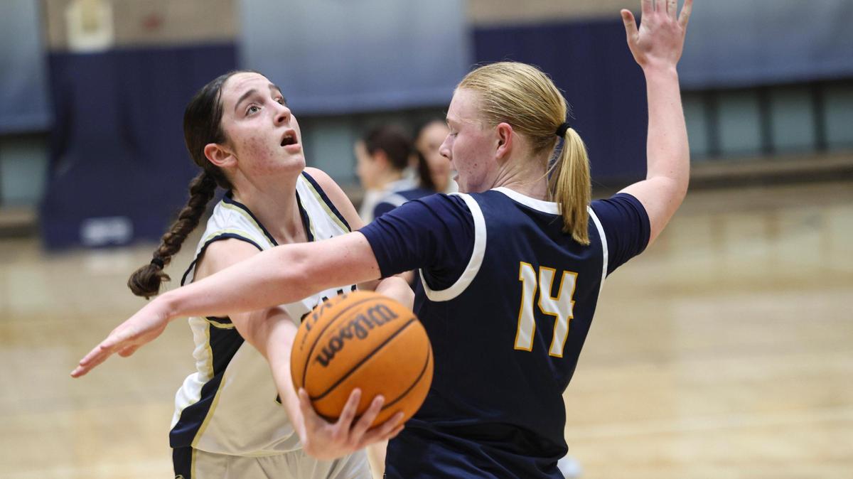 Lillie Parish scoops a shot past Ellie Sloan. Mission Prep girl’s basketball team beat Arroyo Grande 55-51 on Feb. 11, 2025.