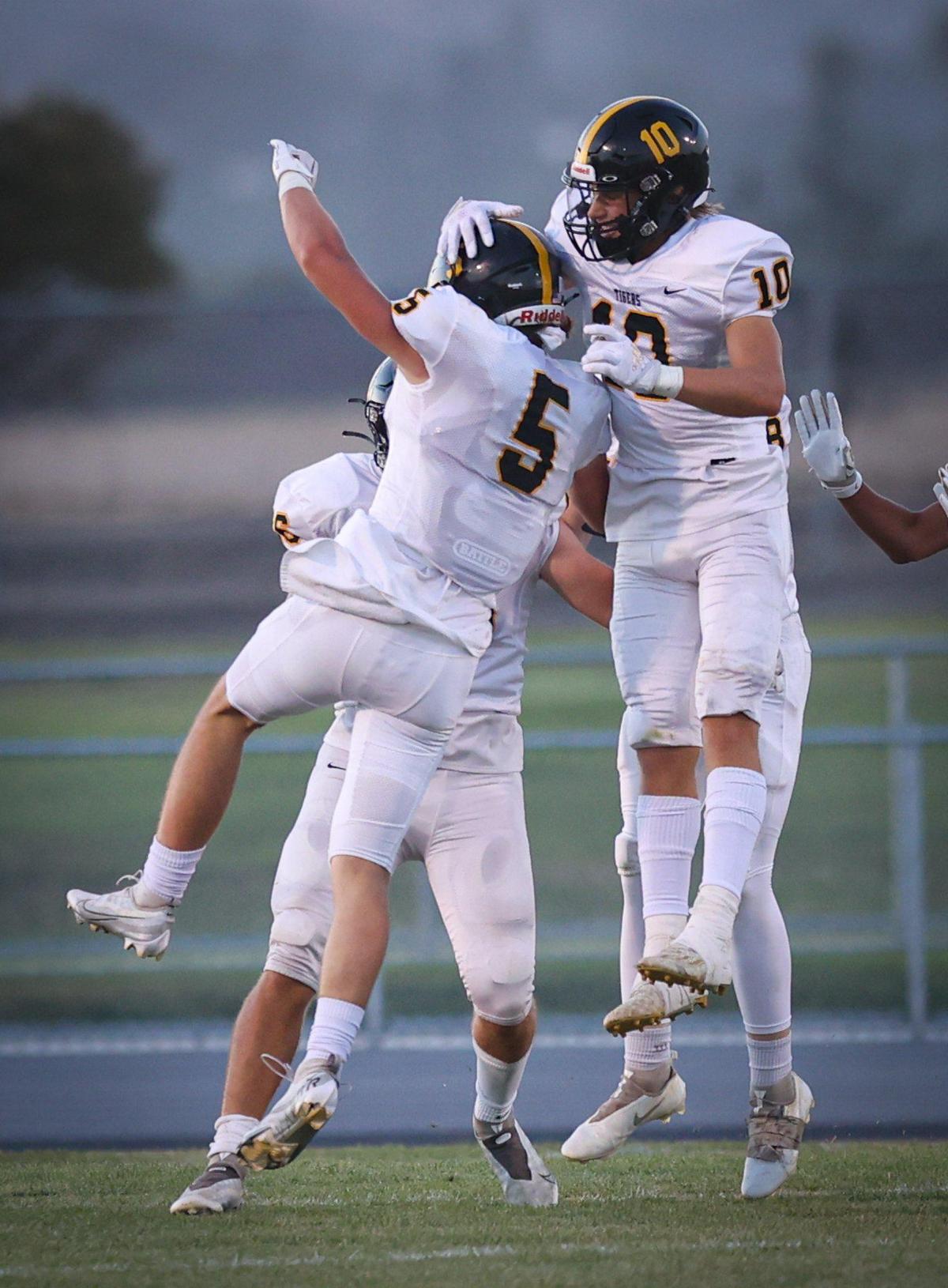 Luca Cuccaro (5) and Eli Smiley Rooney (10) celebrate an interception and return for a touchdown in San Luis Obispo’s 35-0 win over Nipomo in the opening game of the season Aug. 19, 2022.