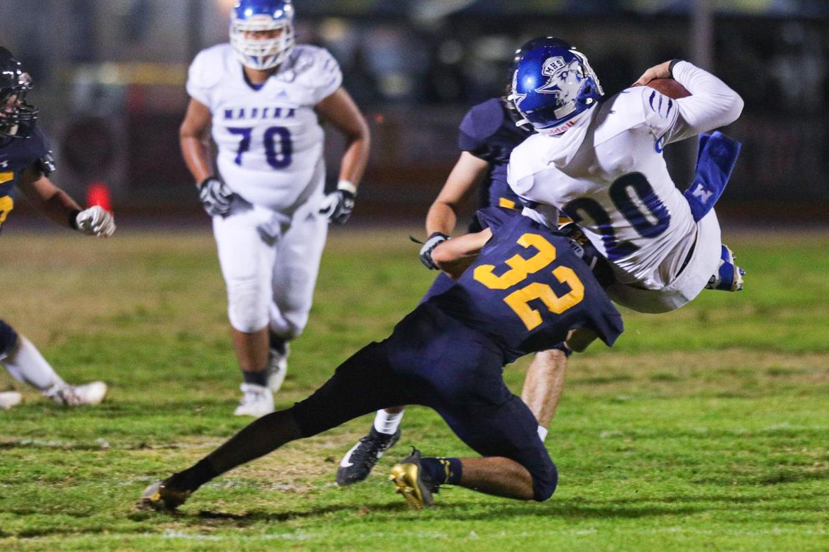Arroyo Grande’s Kaden Tynes upends Madera quarterback Beau Green in the Eagles’ 49-21 first-round playoff win on Nov. 5, 2021.