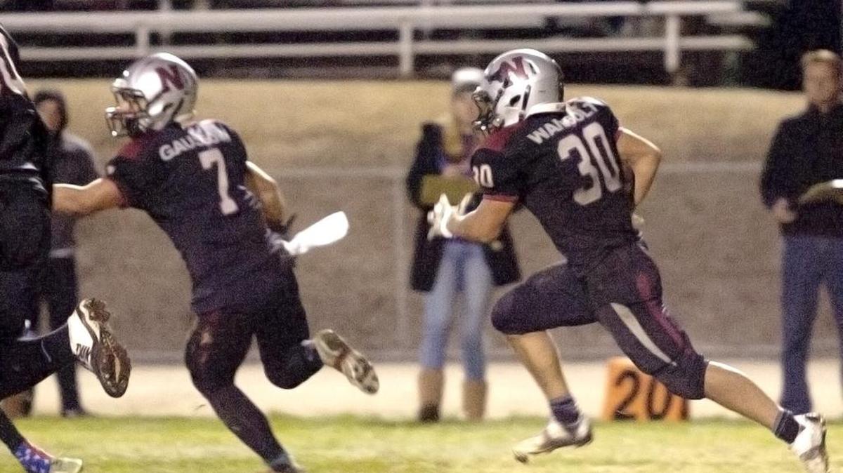 Nipomo High’s Terry Wambolt (30) heads toward the endzone after an interception, with a block from Rich Gaussoin (7), but slips at the 20-yard line.