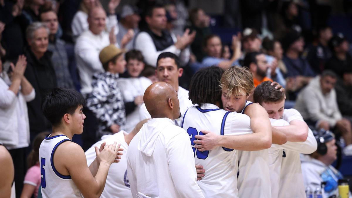 Starters were called off the floor to applause and recognition as the final seconds wound down in Mission Prep’s second-round state tournament loss to San Gabriel Academy on March 6, 2025..From left, Ethan Orozco, Coach Terrance Harris, Jayden Nozil, Brayden Mott and Stokes Wahlen line up for hugs.