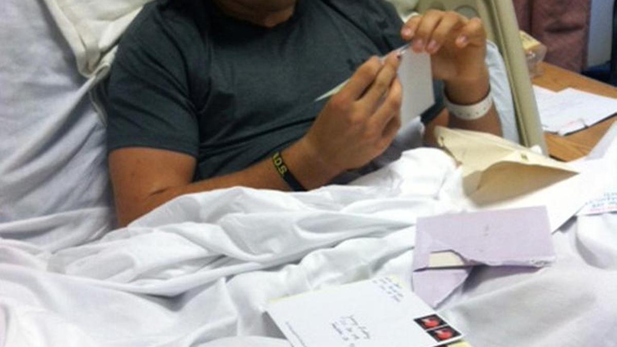 Isaac Lindsey reads letters of support while recovering at Santa Clara Valley Acute Rehabilitation in San Jose.