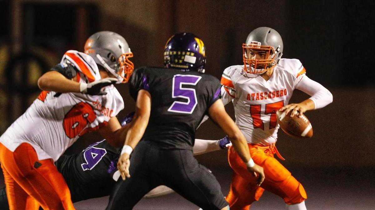 Atascadero quarterback Tyler Chapman scrambles away from the Righetti High School defense at a prep football game in Santa Maria on Friday, October 13, 2017.