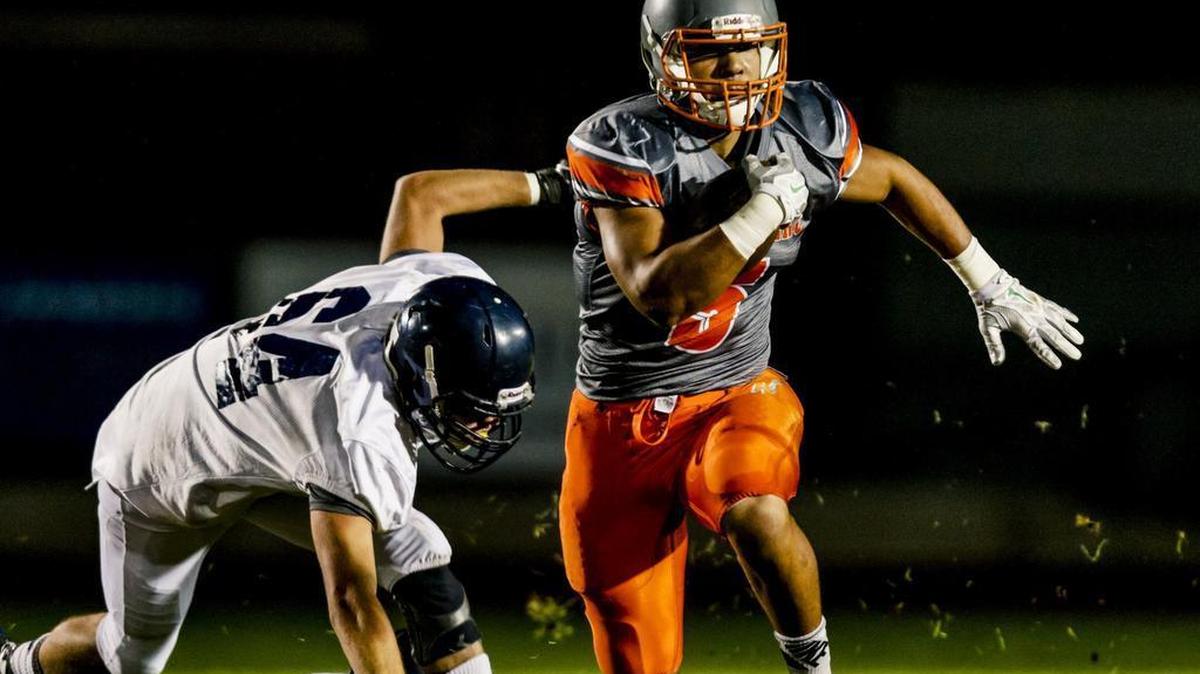 Atascadero High’s Marc Martin gets past Arroyo Grande’s Zack Hepper during Friday night’s game.