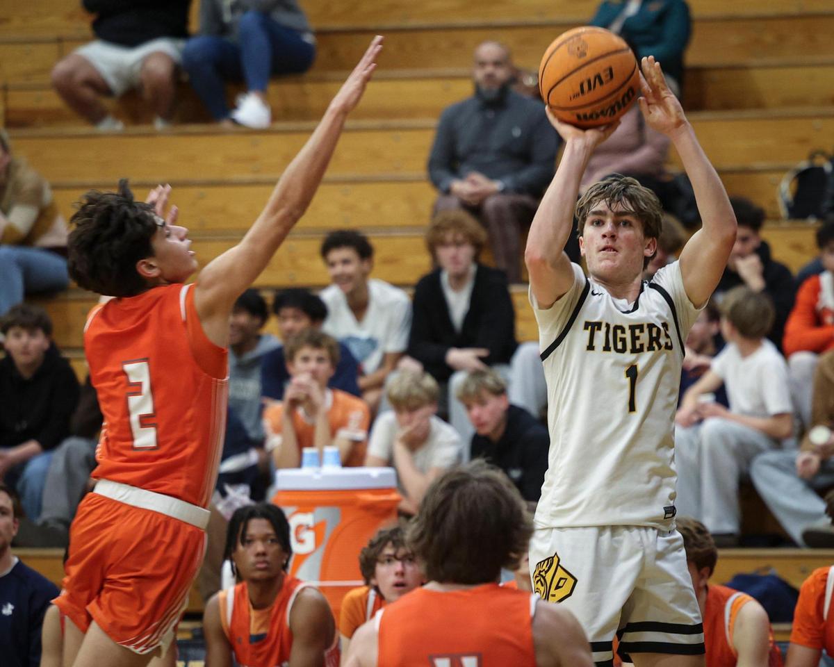 Logan Missler shoots contested by Isaiah Rodriguez. Atascadero High School beat San Luis Obispo 60-57 on Jan. 21, 2025.