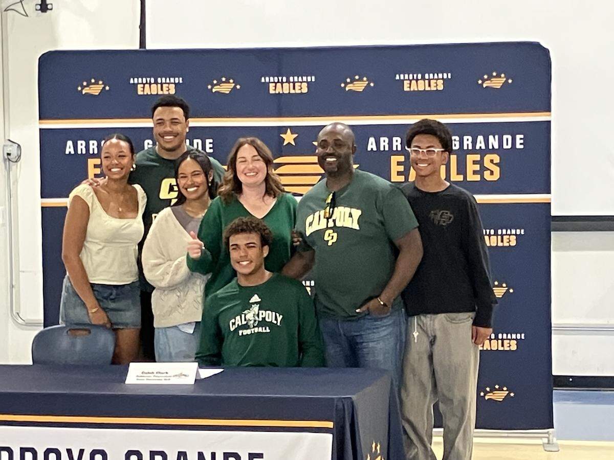 Caleb Clark (seated) along with family members at his signing day at Arroyo Grande High.