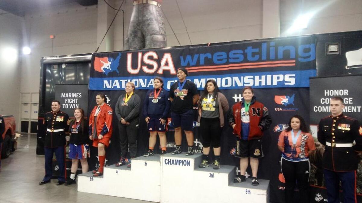 Nipomo High School senior Alexis Garcia (third from right) on the medal stand at the girls wrestling national tournament in Oklahoma City.