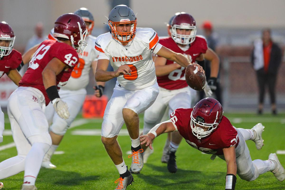 Evan Moscardi is pursued by Bastiaan Jaureguy and Kyler Tweeten. Paso Robles beat Atascadero 21-6 in a football game at War Memorial Stadium on Sept. 17, 2021.