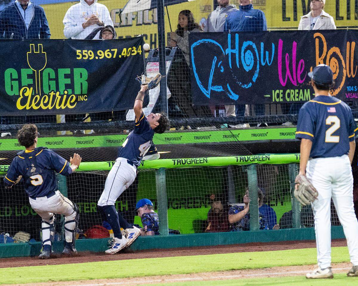 Eagles players chase a pop up in foul ground.