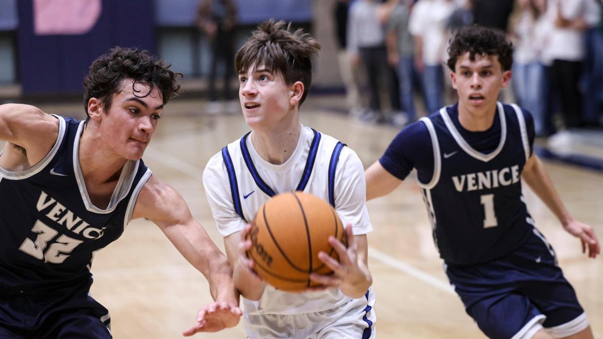Brody Miller drives to basked defended by Richie Durant. Mission Prep beat Venice 70-64 on Feb. 27, 2025 in the first round of CIF State Championship playoffs.